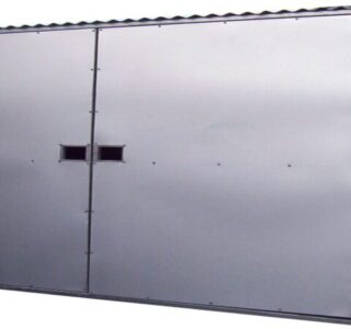 Gray modular steel container with small square windows, isolated against a plain background.