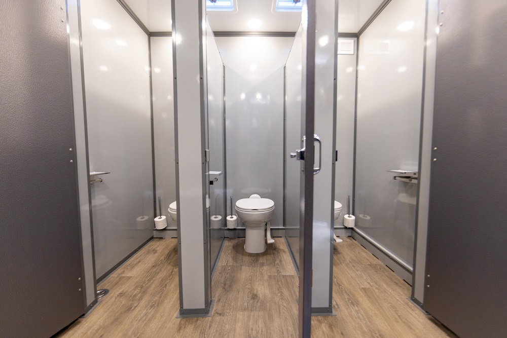 Interior view of a mobile bathroom unit with multiple stalls and toilets