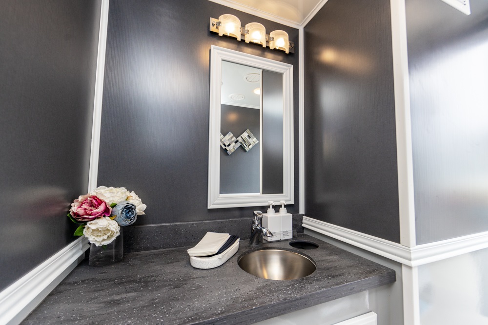 Modern mobile bathroom interior with sink, mirror, and floral arrangement