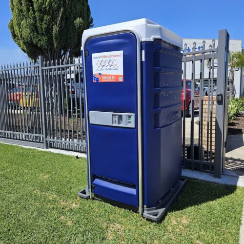 Blue Five Star Event Chemical Toilet with LED Lighting next to a fence and tree in a sunny outdoor setting.