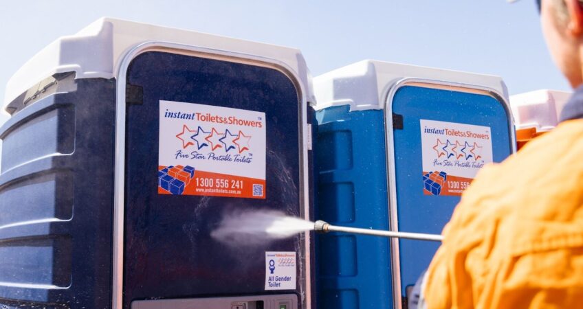 how do i stop my portable toilet from smelling - Worker cleaning portable toilets with a high-pressure washer.