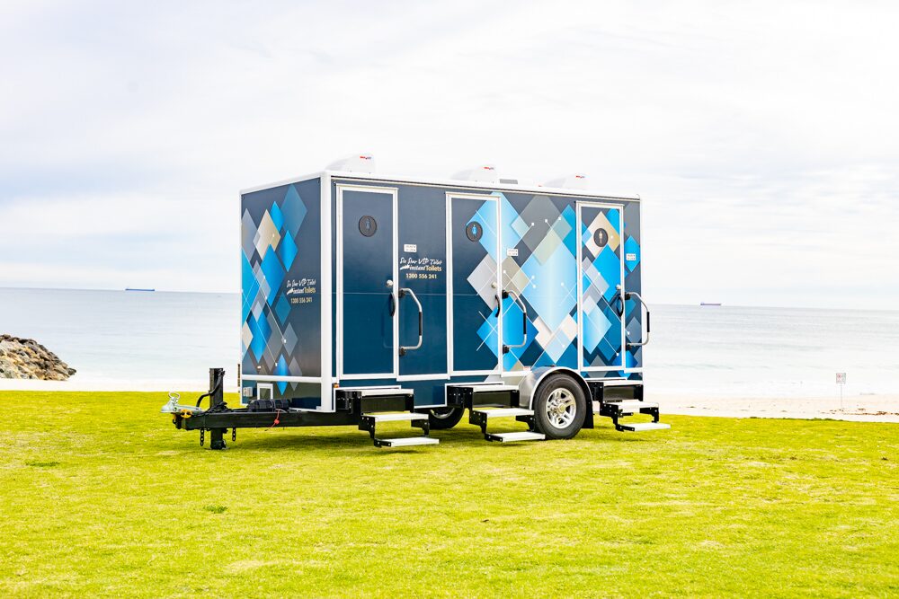 Portable toilet 4-pan series parked on a grassy area