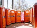 Row of orange portable toilets supplied by Instant Toilets & Showers at the FIFA Women’s World Cup Fan Zone in Perth, 2023